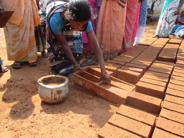 Woman from WVT making bricks