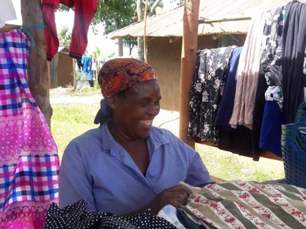 Mary Ondisa smiling at her clothing stall