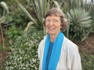 Jackie Stillwell wearing a blue scarf and a white top in Kenya.