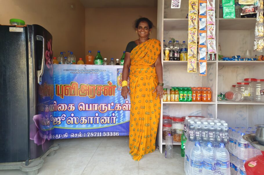 Kavitha stands in front of the juice stand she runs.